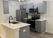 Thumbnail 14 of 14 - A modern kitchen with a staircase leading to the upper floor at The Atlantic Brookhaven, Georgia, 30329
