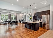 Thumbnail 7 of 15 - Kitchen with stainless steel appliances and a wooden floor at The Atlantic Mountain Island, Charlotte
