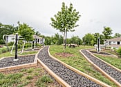 Thumbnail 15 of 15 - Path through a park with trees and benches at The Atlantic Mountain Island, Charlotte, North Carolina