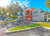 Thumbnail 9 of 34 - A row of houses with cars parked in front at Reserve at Canyon Creek, San Antonio