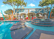 Thumbnail 6 of 34 - A pool with a water slide and a building in the background at Reserve at Canyon Creek, San Antonio,TX,78230