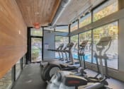 Thumbnail 11 of 16 - Gym with cardio equipment and views of the pool at The Atlantic Briarcliff, Georgia, 30329