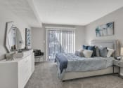 Thumbnail 9 of 16 - Bedroom with a bed and a dresser and a window at The Atlantic Briarcliff, Atlanta, GA, 30329