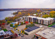Thumbnail 6 of 17 - an aerial view of an apartment complex with a river in the background