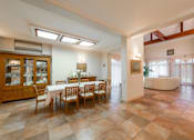 Thumbnail 1 of 17 - A dining room with a table set for six.