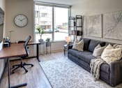 Thumbnail 43 of 43 - Kalamazoo, MI Apartments - Open-Floor Living Room With High Ceilings, Wood-Inspired Plank Flooring, And An Expansive Window With Roller Shades