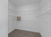 Thumbnail 15 of 30 - a room with white walls and a white closet with shelves and a window in it at Tivoli Green Apartments & Townhomes, Mount Pleasant, WI