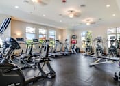 Thumbnail 4 of 30 - A spacious gym with a variety of exercise equipment.