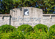 Thumbnail 28 of 30 - A sign that says "The Preserve at Prairie Creek" is surrounded by green bushes.