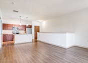 Thumbnail 25 of 30 - A large empty room with wooden floors and white walls.