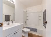 Thumbnail 8 of 13 - bathroom with toilet, sink, and shower