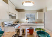 Thumbnail 12 of 20 - kitchen bar with view of stove and sink