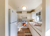Thumbnail 11 of 20 - kitchen with stove, fridge, and sink