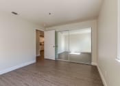 Thumbnail 7 of 27 - bedroom with mirrored closet doors