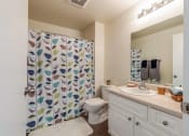 Thumbnail 6 of 27 - bathroom with shower curtain, toilet, and vanity