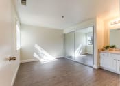 Thumbnail 5 of 27 - bedroom with vanity and mirrored closet doors