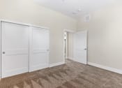 Thumbnail 11 of 12 - bedroom with closet doors and carpet