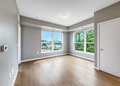 Thumbnail 9 of 22 - A spacious room with a view of the city through the windows.