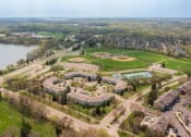Thumbnail 30 of 30 - Lakeview Commons Apartments aerial photo with glimpse of nearby sports fields