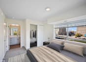 Thumbnail 51 of 58 - A bedroom with a large bed and a view of the city.