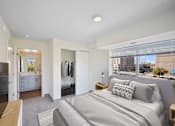 Thumbnail 55 of 58 - A bedroom with a large bed and a view of the city.
