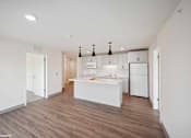 Thumbnail 48 of 58 - A kitchen with white appliances and a white island.