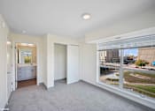 Thumbnail 47 of 58 - A spacious, empty room with a view of the city outside the window.