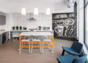 Thumbnail 17 of 37 - a kitchen with a white table and orange stools