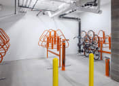 Thumbnail 36 of 37 - the bike rack in the new building has been updated with orange poles and a wall