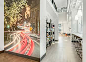 Thumbnail 12 of 37 - A long hallway with a mural of a city street on the wall.
