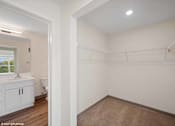 Thumbnail 7 of 58 - A white bathroom with a toilet, sink, and a window.