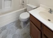 Thumbnail 14 of 20 - A white toilet sits in a bathroom next to a sink.
