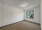 Thumbnail 19 of 28 - A room with a carpeted floor and a window.