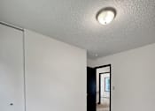 Thumbnail 21 of 28 - A room with a carpeted floor and a white door.