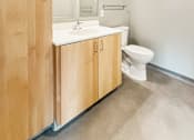 Thumbnail 6 of 22 - A bathroom with a toilet, sink, and medicine cabinet.
