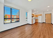 Thumbnail 5 of 46 - A spacious living room at Stryker Senior Apartments in West St. Paul with wooden floors and white walls.