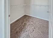 Thumbnail 6 of 31 - A small, empty room with a carpeted floor and white walls.