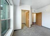 Thumbnail 6 of 21 - A room with two doors and a window.