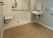 Thumbnail 16 of 20 - A bathroom with a walk-in shower and a sink.