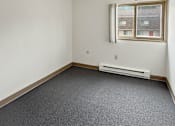 Thumbnail 23 of 29 - A photo of a Liberty Plaza Apartment bedroom with window and carpeted floor