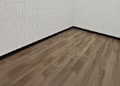 Thumbnail 27 of 29 - A room with wooden flooring and white tiled walls.