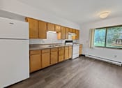 Thumbnail 26 of 29 - A kitchen with wooden cabinets and a white refrigerator.