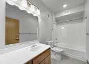 Thumbnail 11 of 35 - A bathroom with vanity, toilet, shower and tub