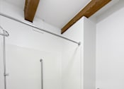 Thumbnail 34 of 34 - A white toilet sits next to a white bathtub in a bathroom.