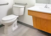 Thumbnail 15 of 21 - A white toilet sits next to a sink in a bathroom at The Lumin in the Highland Park neighborhood of St Paul.