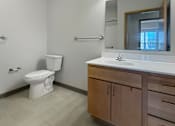 Thumbnail 22 of 35 - A bathroom with vanity,  a light bar and a toilet