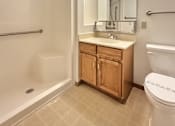 Thumbnail 16 of 16 - A bathroom with a toilet, sink, and bathtub.