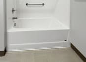 Thumbnail 23 of 35 - A white bathtub with a shower curtain rod above it.