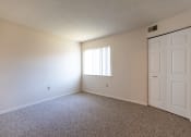 Thumbnail 17 of 30 - bedroom looking toward window. Vacant with carpet.