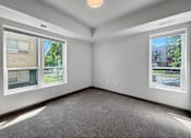 Thumbnail 7 of 35 - a bedroom with 2 large windows